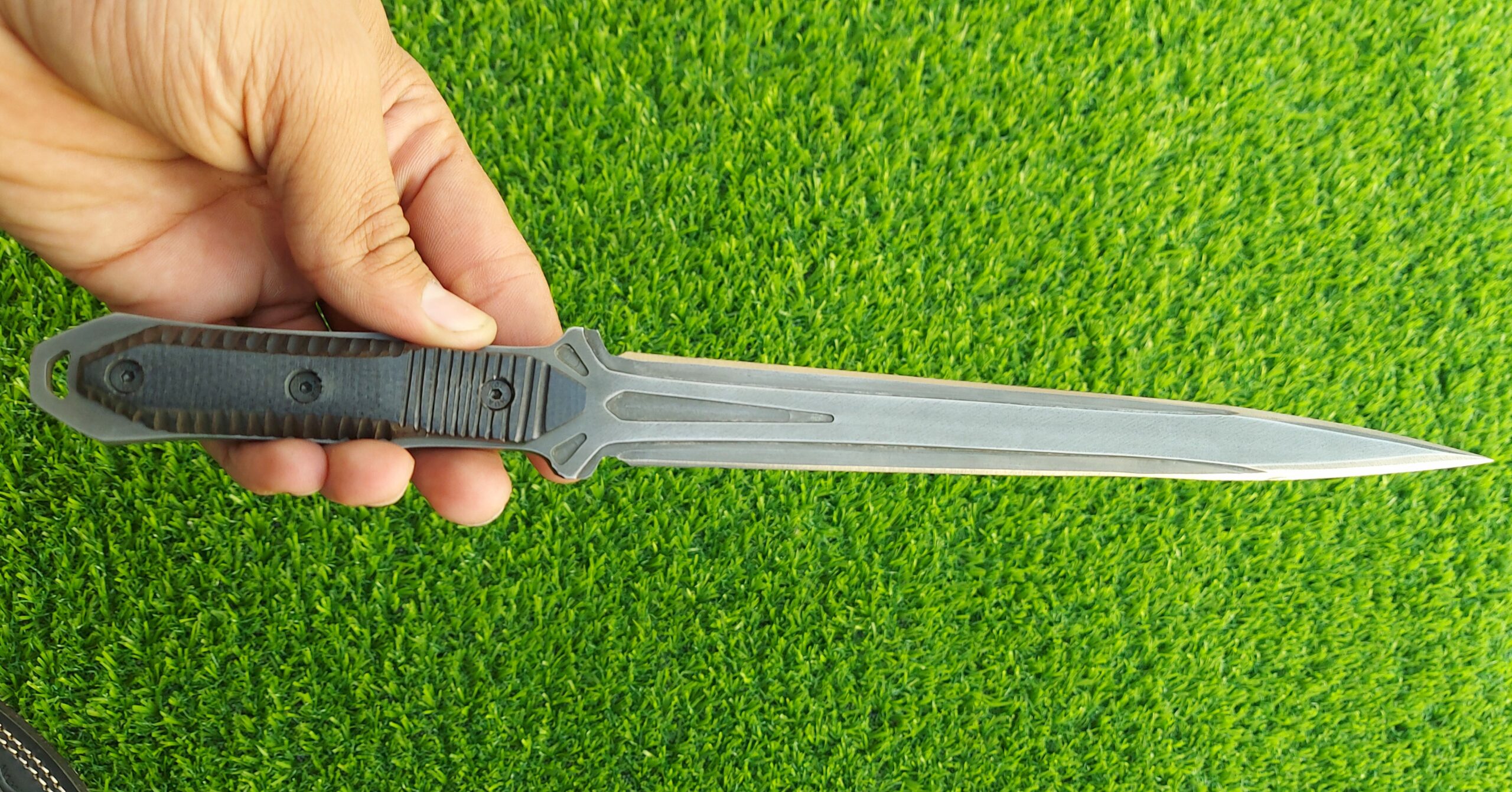 The handmade stainless steel stiletto knife features an intricately acid-washed blade, offering a unique, rugged appearance while maintaining superior sharpness and durability for precise, tactical use. - Image 3