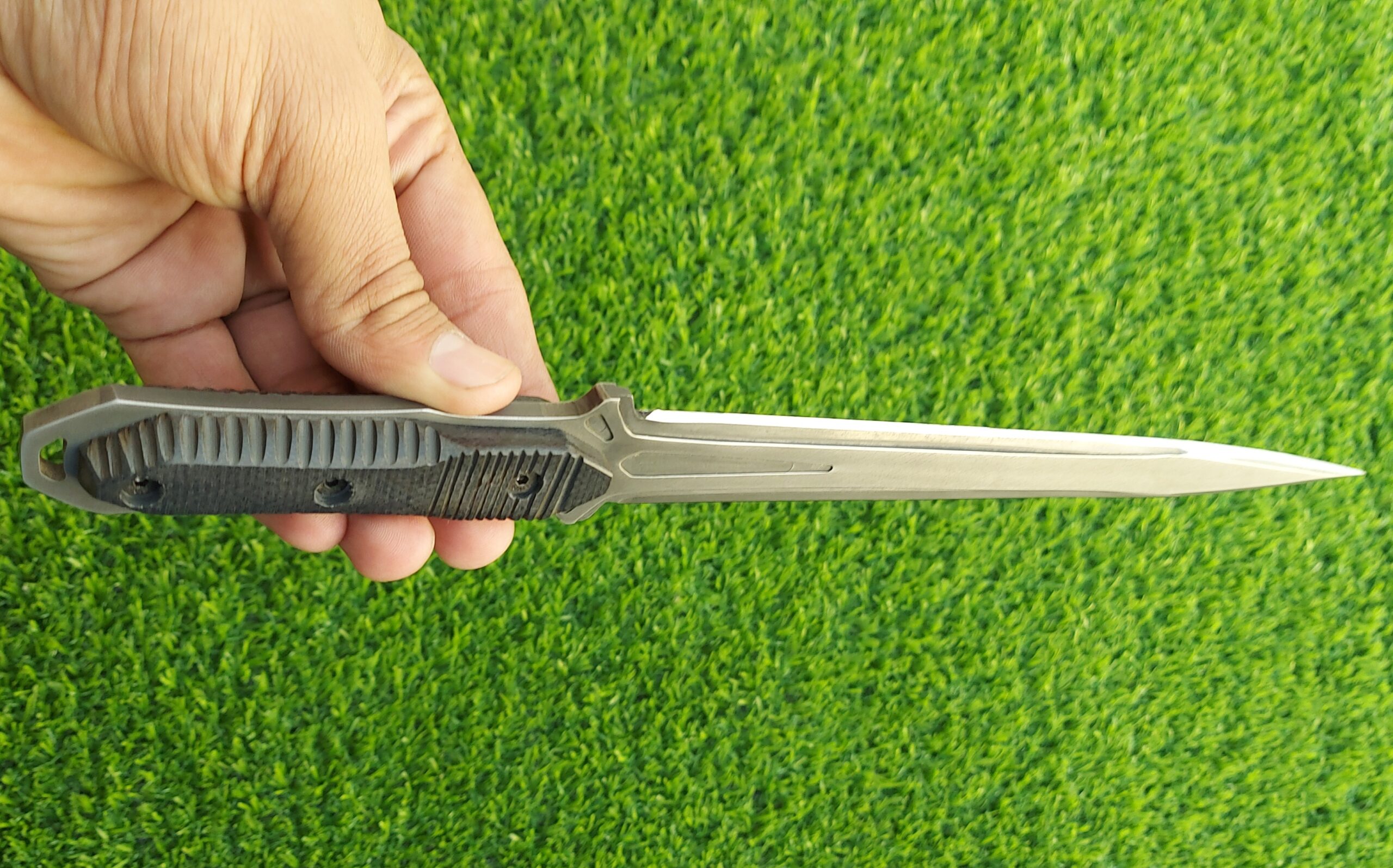 The handmade stainless steel stiletto knife features an intricately acid-washed blade, offering a unique, rugged appearance while maintaining superior sharpness and durability for precise, tactical use. - Image 4