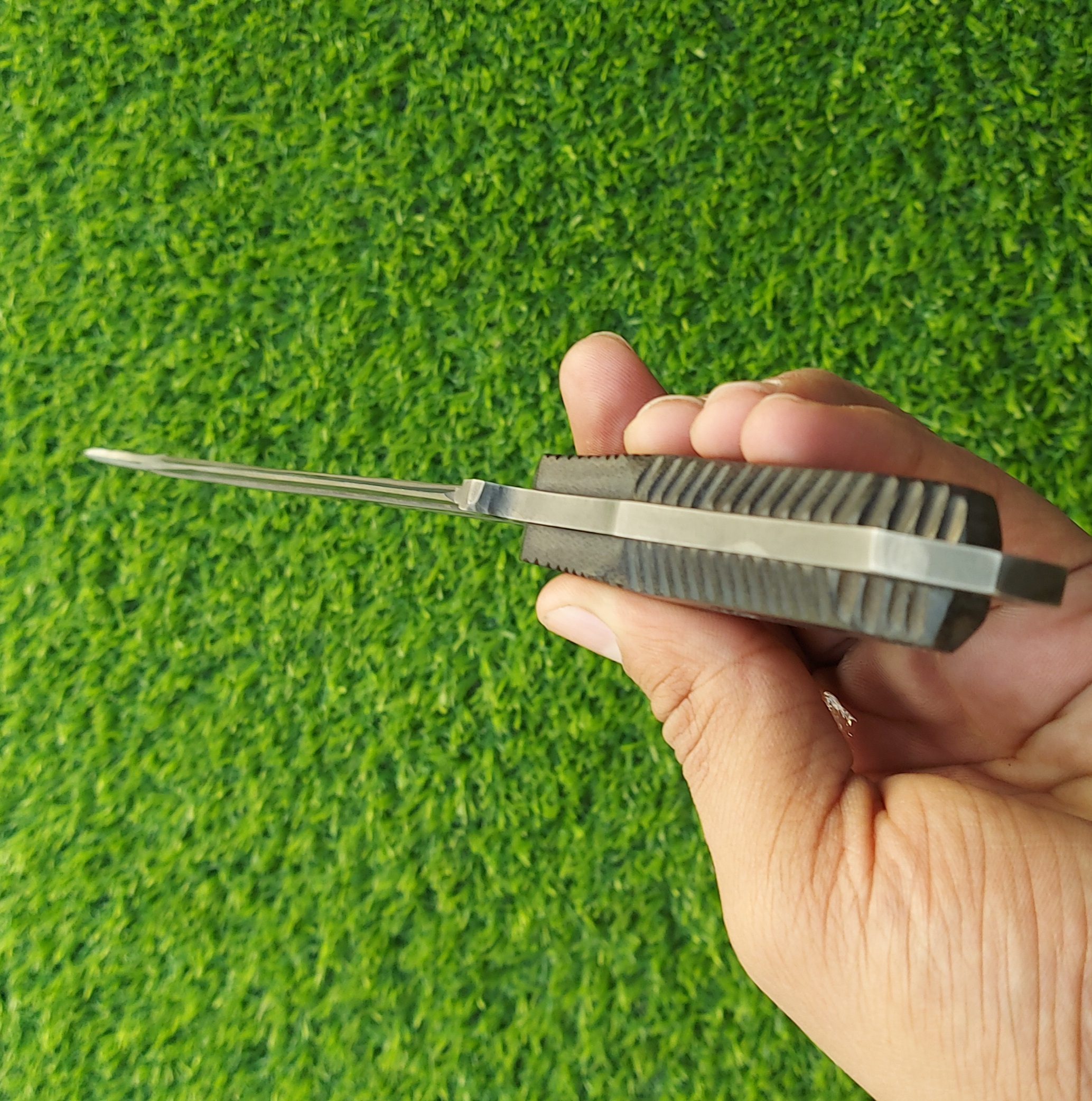 The handmade stainless steel stiletto knife features an intricately acid-washed blade, offering a unique, rugged appearance while maintaining superior sharpness and durability for precise, tactical use. - Image 5