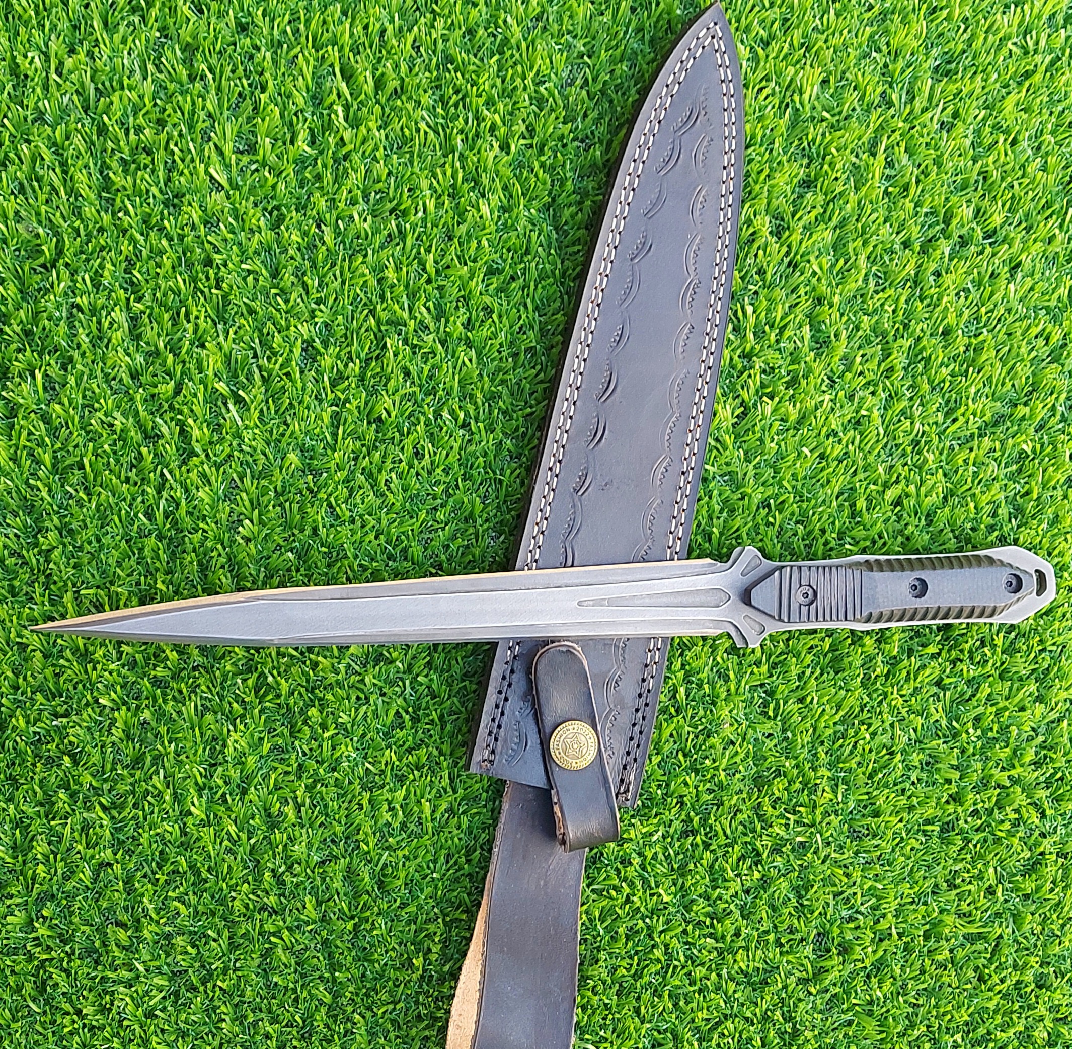 The handmade stainless steel stiletto knife features an intricately acid-washed blade, offering a unique, rugged appearance while maintaining superior sharpness and durability for precise, tactical use.